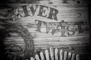 The words River Twist against a wooden background.